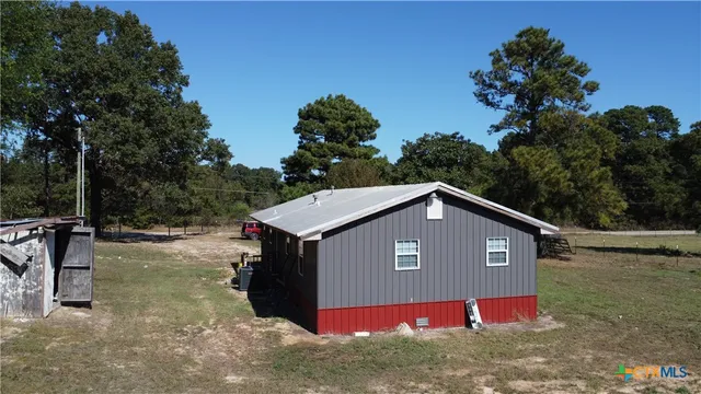 a view of barn house with a yard