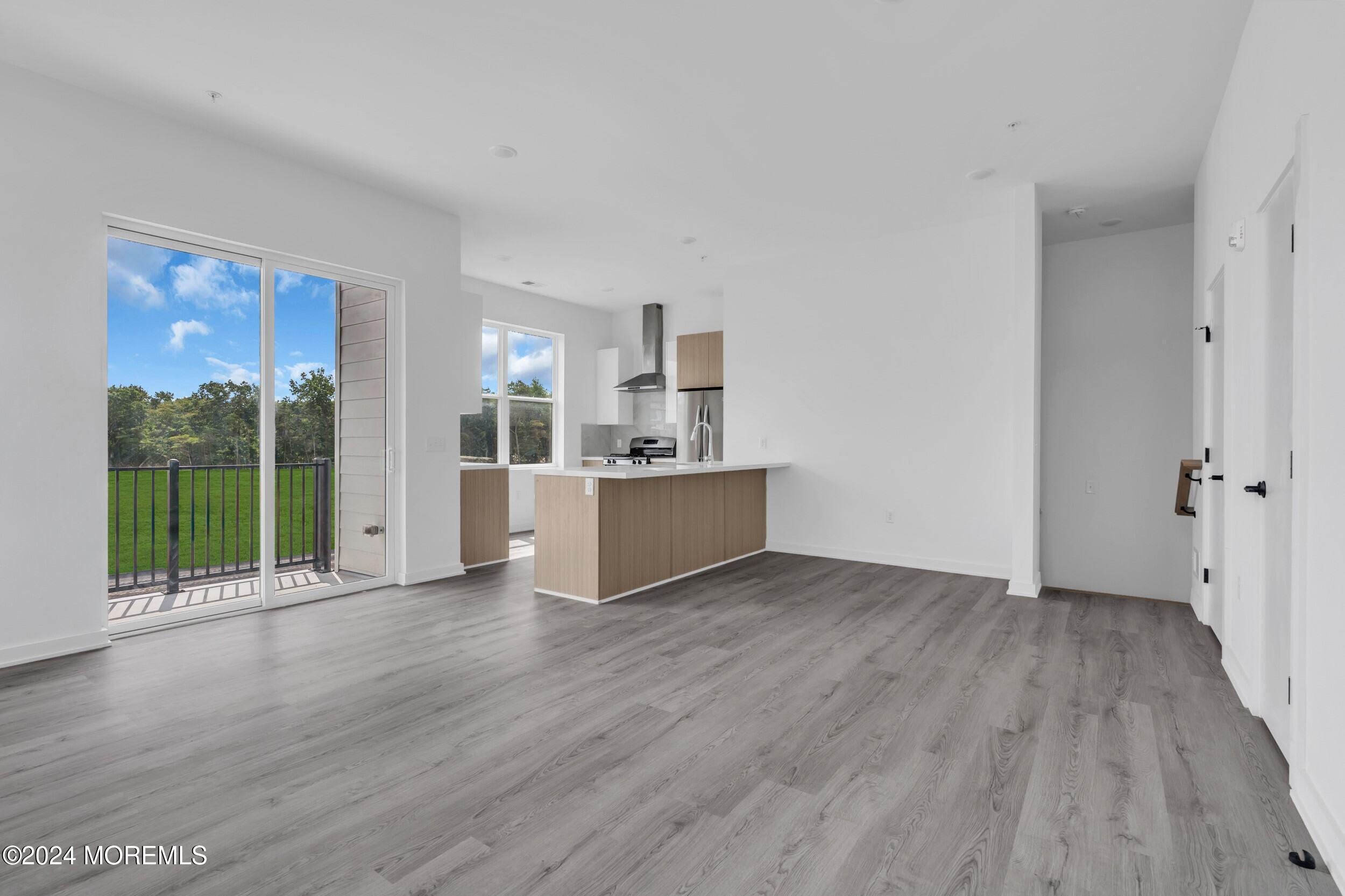 603 Texas Road Old Bridge, NJ 08857 - Photo 4 of 17 a view of a kitchen with wooden floor and a floor to ceiling window