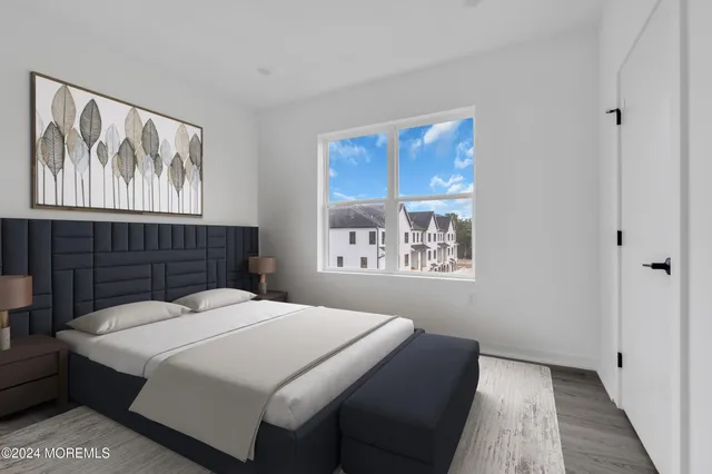 a bedroom with a bed and a painting on the wall