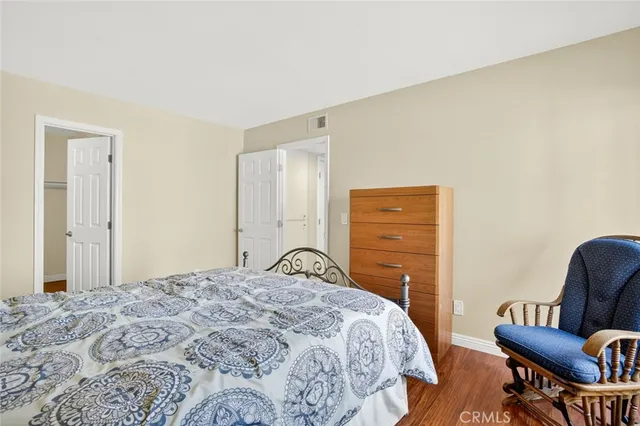 a bedroom with a bed and a mirror