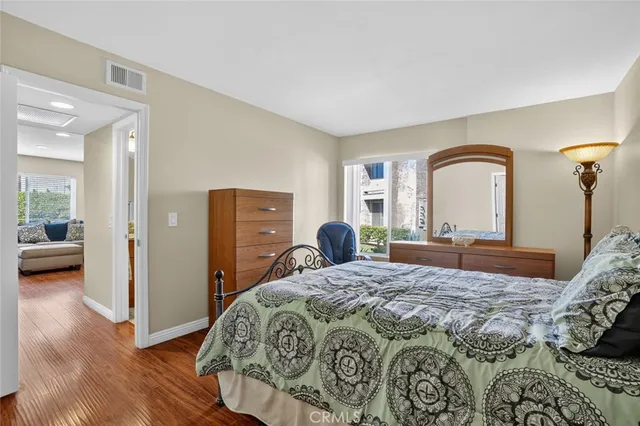 a bathroom with a granite countertop sink a toilet and a mirror