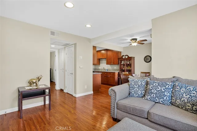 a living room with furniture and kitchen view