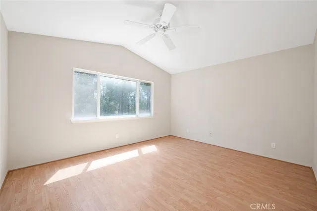 a white bath tub sitting under a bathroom window and a shower