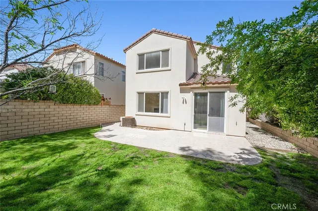 an aerial view of a house with a yard and garden