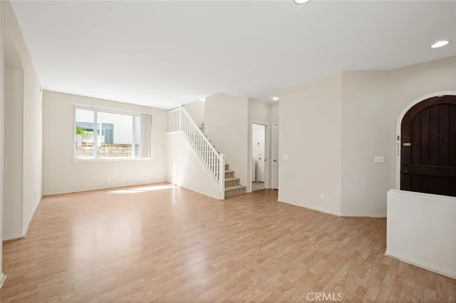 a view of a big room with windows and chandelier