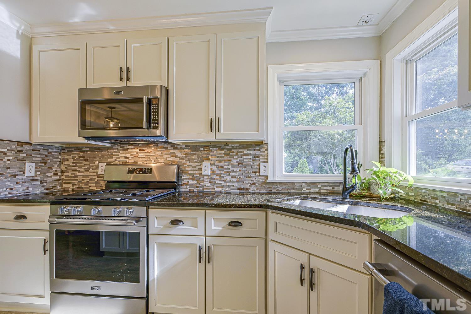 Recent kitchen renovations!  Gorgeous GRANITE counters, STAINLESS appliances, TILE backsplash and beautiful new TILE flooring extends into the breakfast area, foyer and hallway.