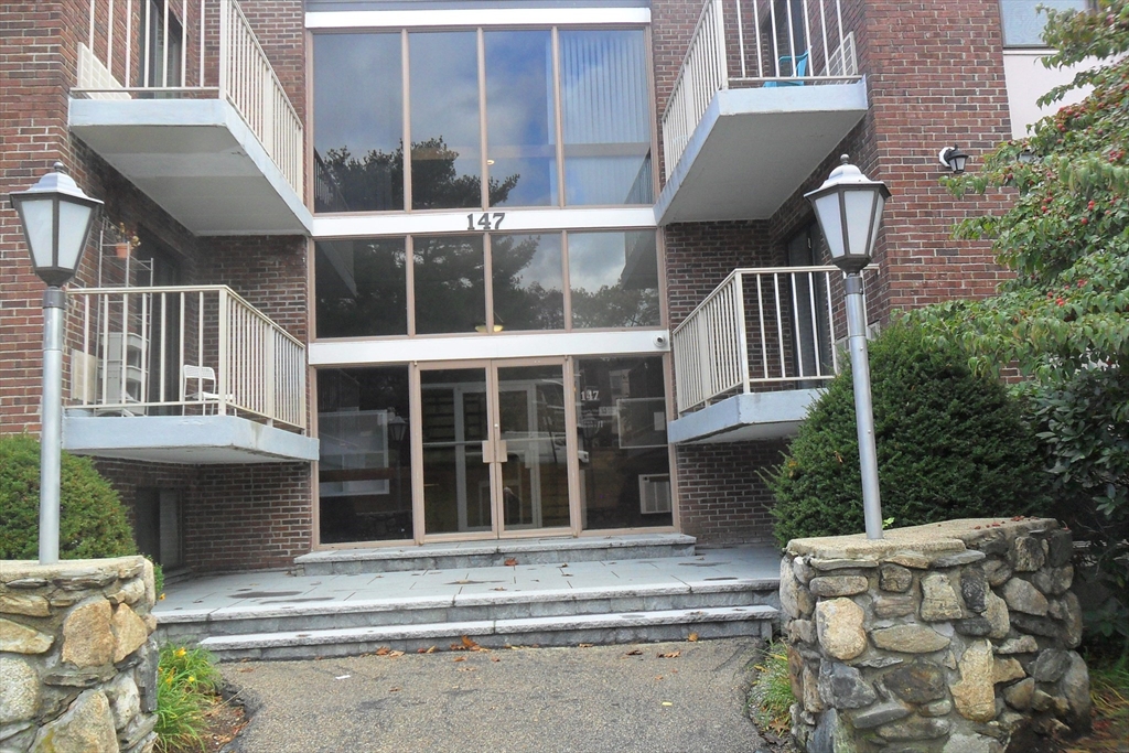 a building exterior with stairs and furniture