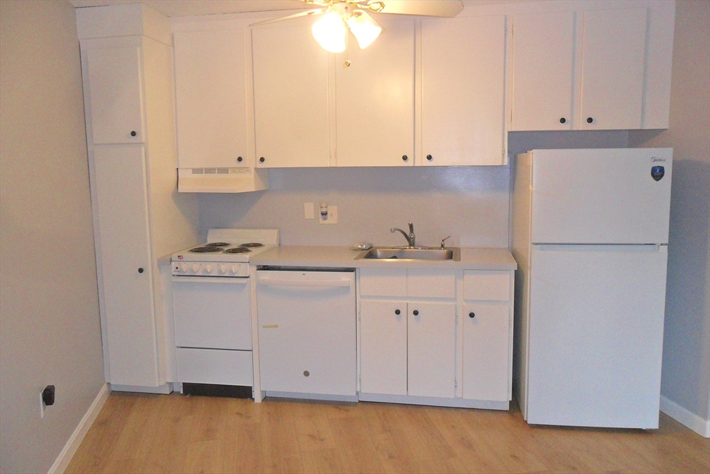 147 Turner Road, Unit 114 Holliston, MA 01746 - Photo 6 of 15 a kitchen with cabinets and white appliances