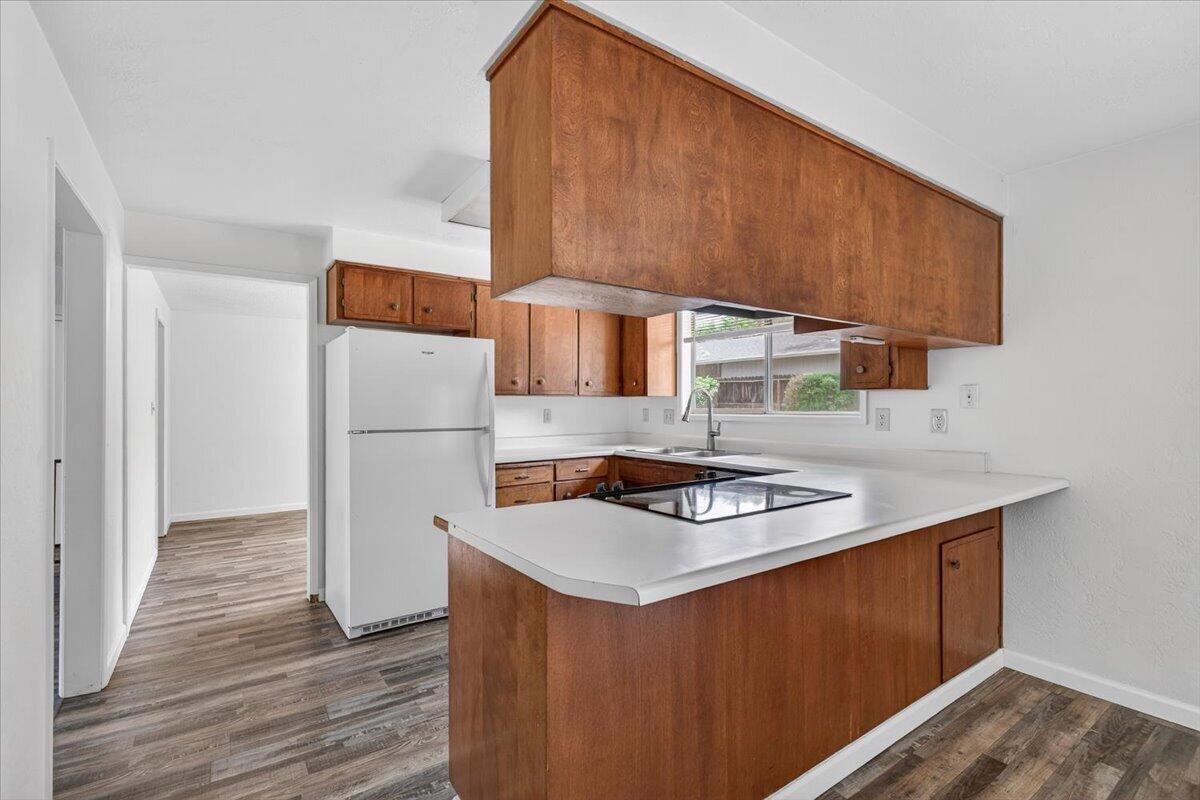415 Sutter Avenue Medford, OR 97504 - Photo 10 of 28 a kitchen with stainless steel appliances a sink a refrigerator and a stove