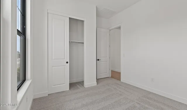 an empty room with windows and entrance