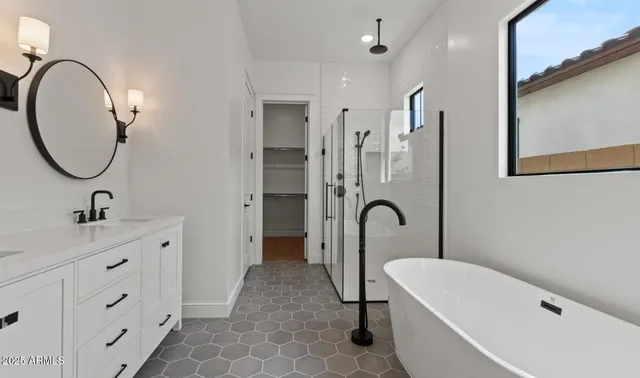 a view of a room with wooden floor and a ceiling fan