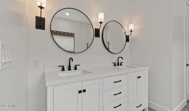 a white bath tub sitting next to a bathroom sink