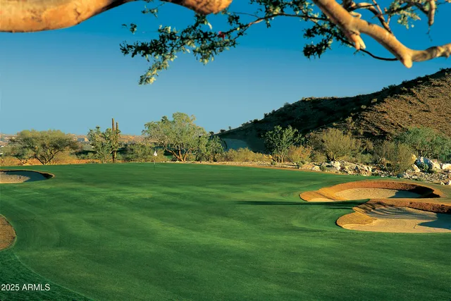 a view of a backyard with table and chairs under an umbrella