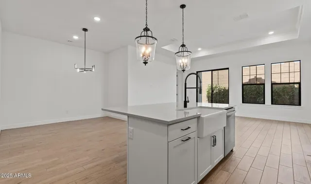 a kitchen with stainless steel appliances a refrigerator sink and stove