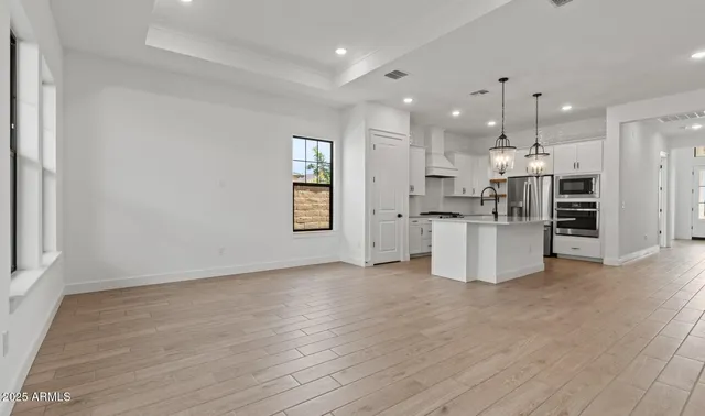a view of a kitchen with refrigerator and a chandelier