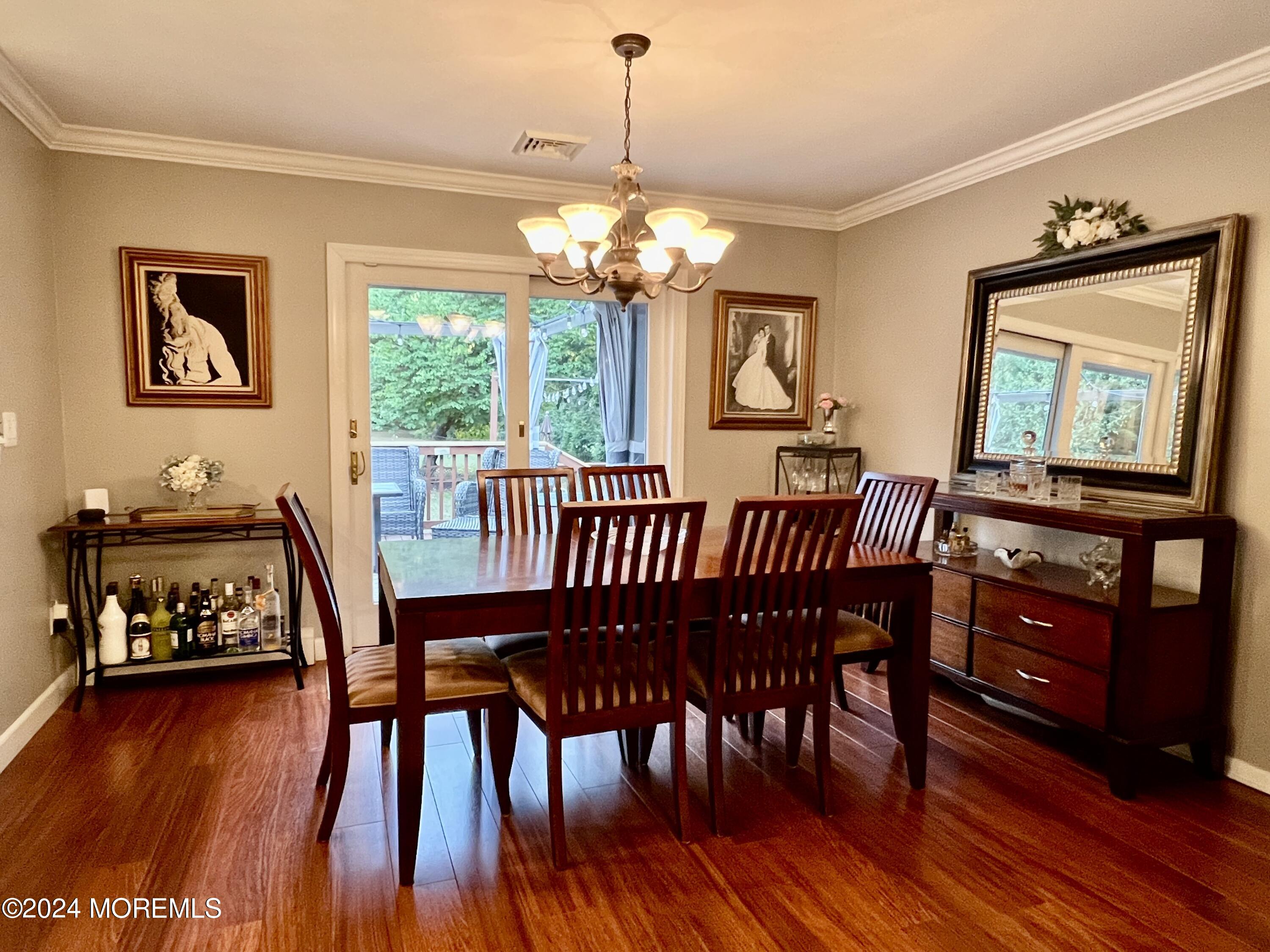 51 Lloyd Road Morganville, NJ 07751 - Photo 13 of 54 a view of a dining room with furniture window and wooden floor