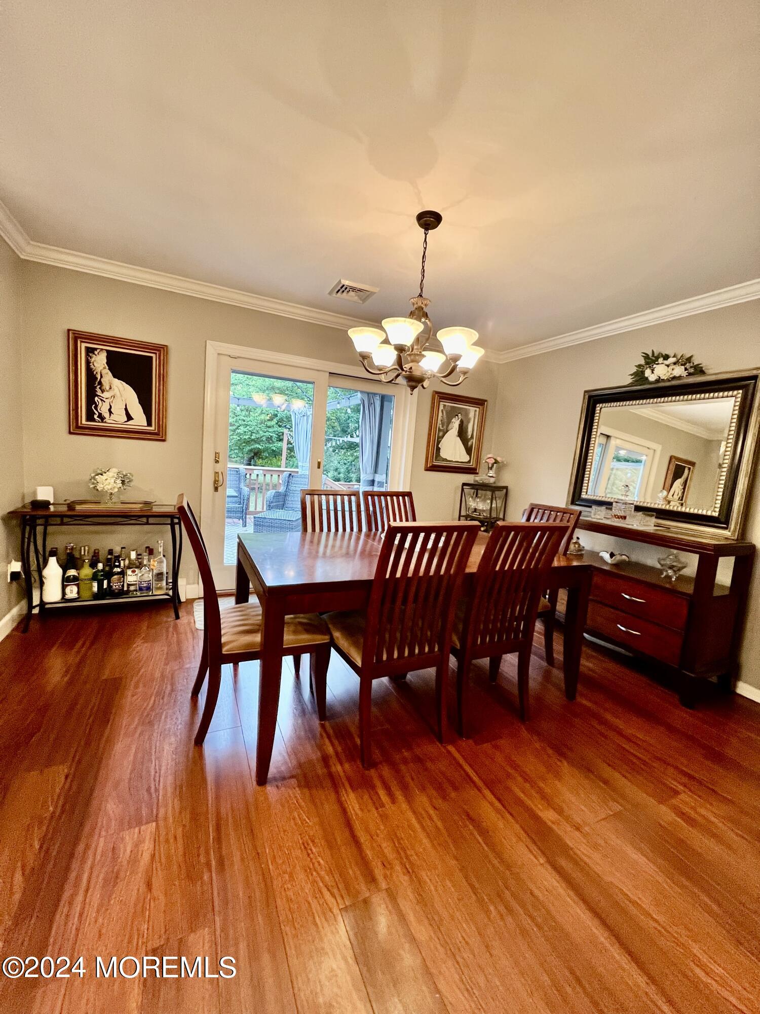 51 Lloyd Road Morganville, NJ 07751 - Photo 14 of 54 a view of a dining room with furniture window and wooden floor