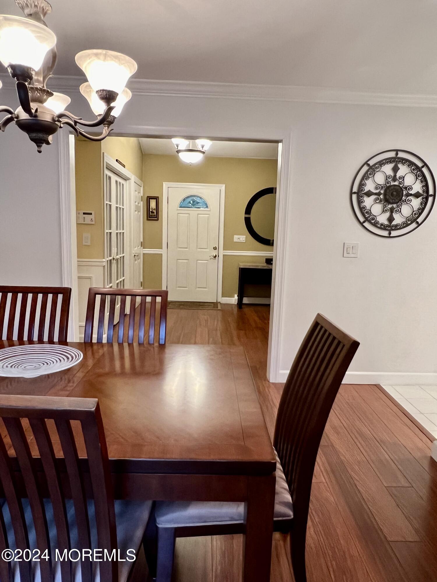 51 Lloyd Road Morganville, NJ 07751 - Photo 15 of 54 a view of a room with furniture and a chandelier