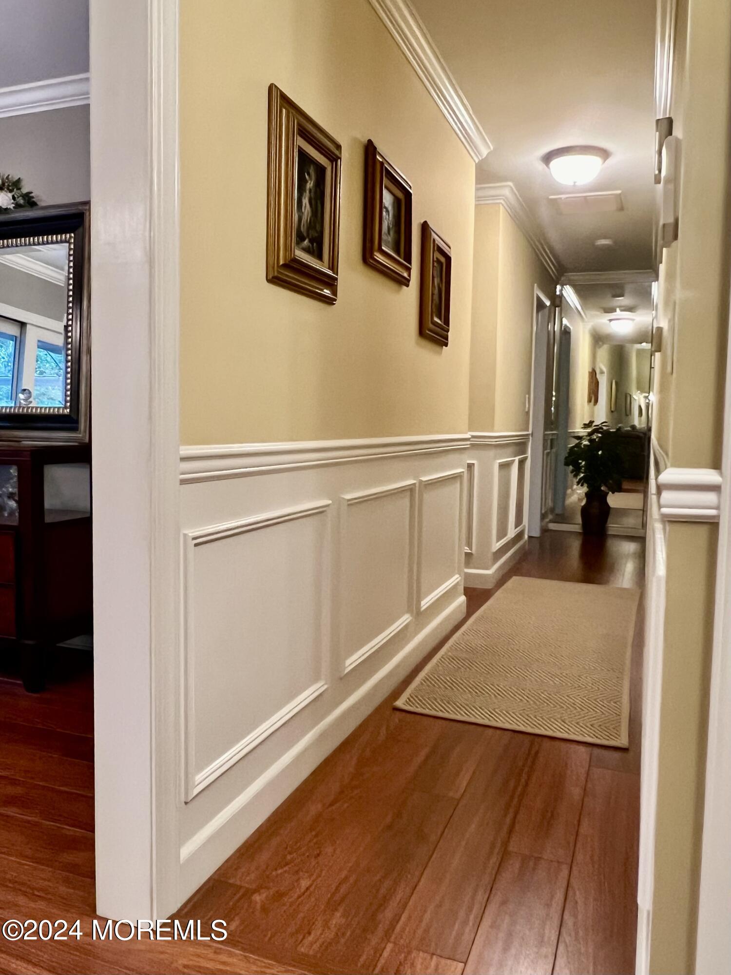 51 Lloyd Road Morganville, NJ 07751 - Photo 16 of 54 a view of a hallway with the wooden floor and dining room