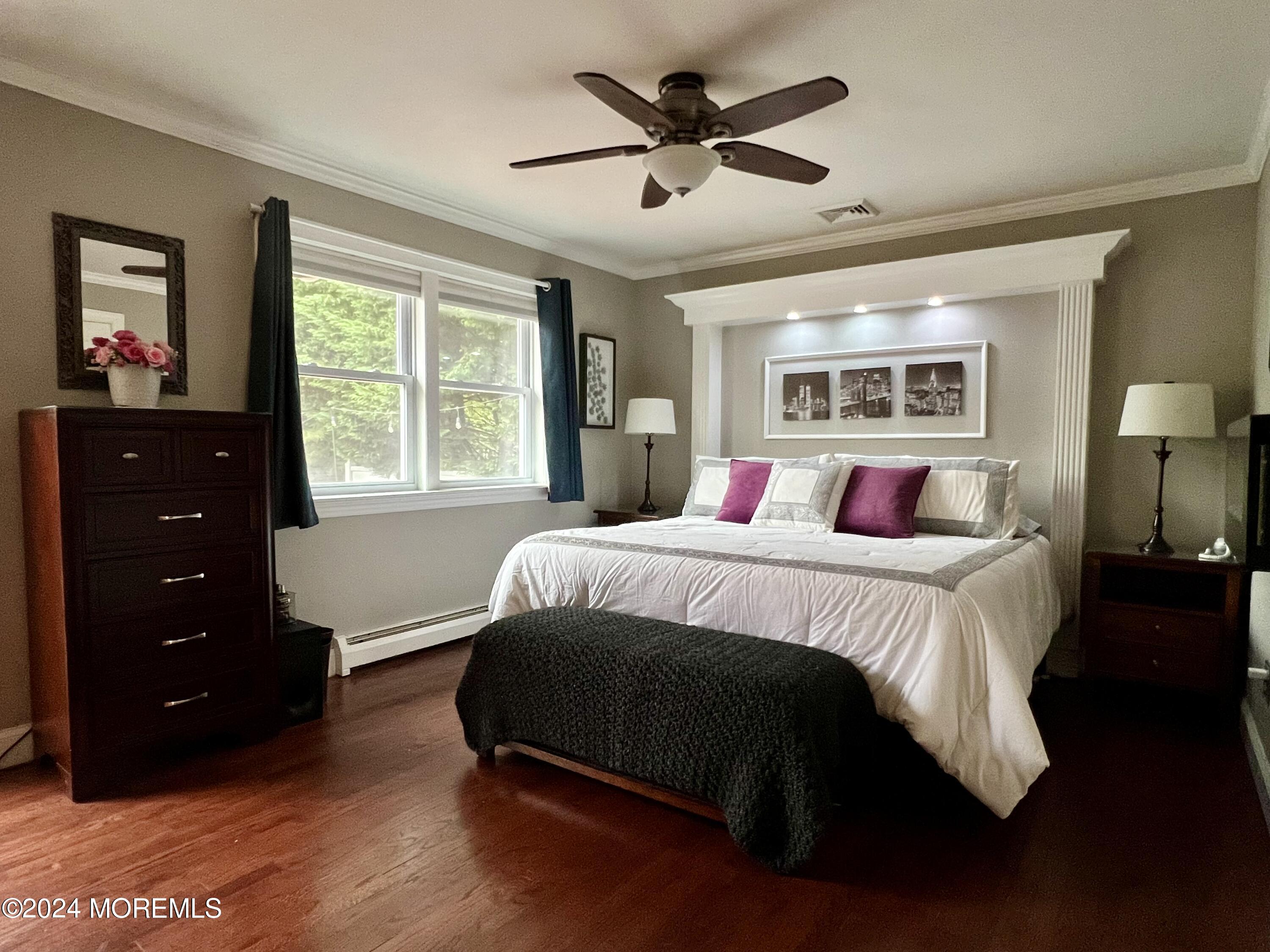 51 Lloyd Road Morganville, NJ 07751 - Photo 19 of 54 a bedroom with a large bed and a window