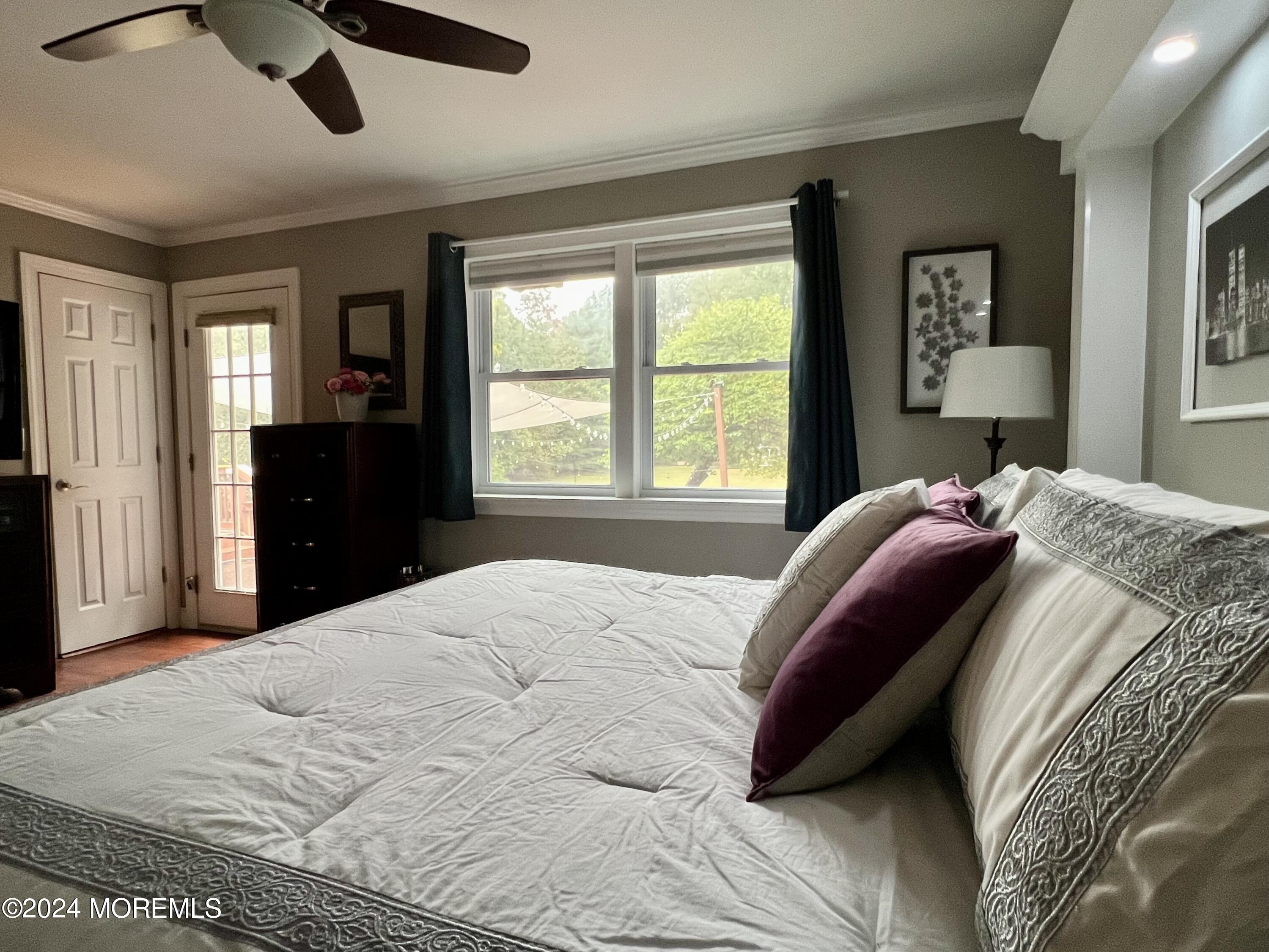 51 Lloyd Road Morganville, NJ 07751 - Photo 20 of 54 a bedroom with a bed and a large window