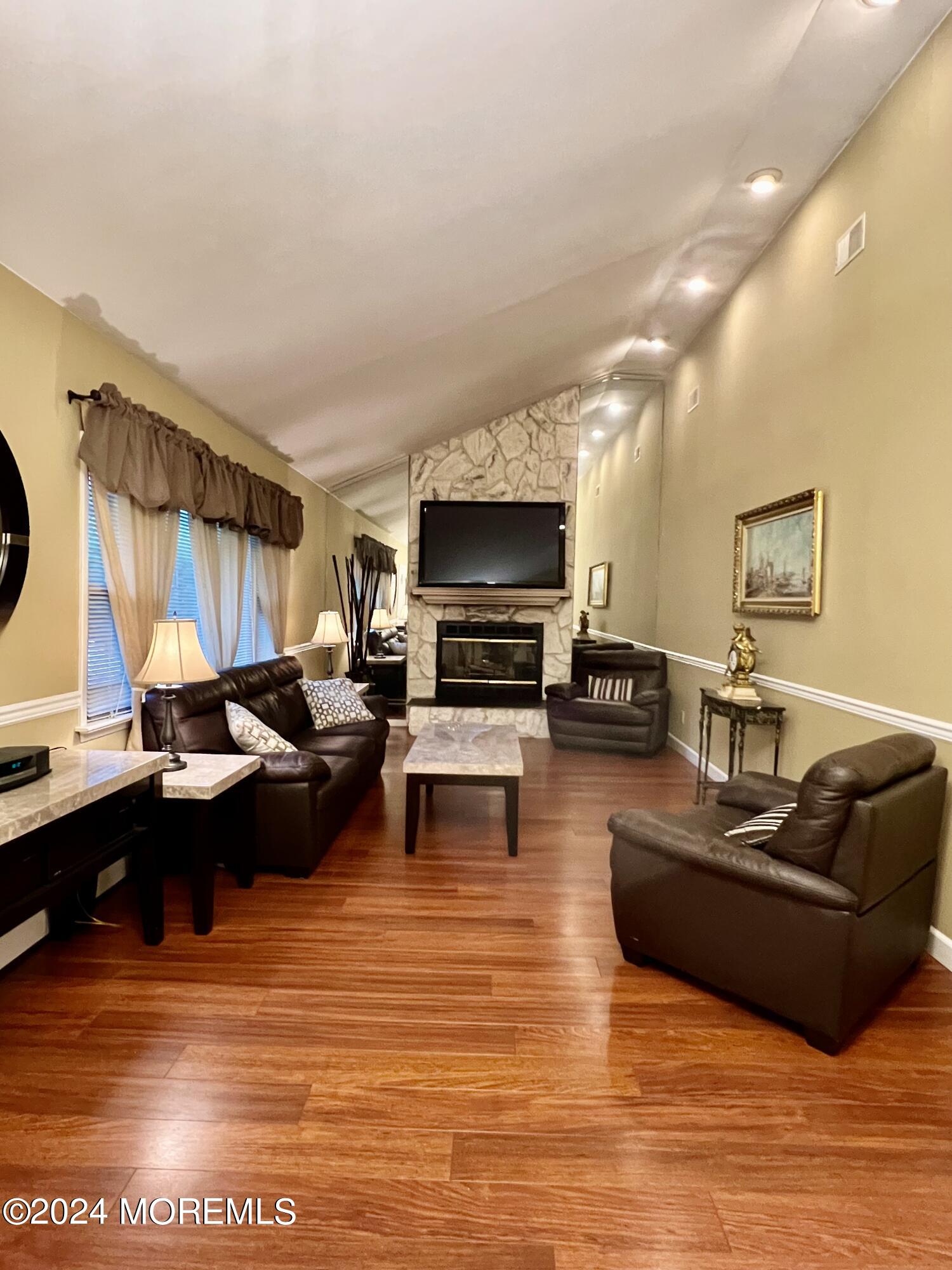 51 Lloyd Road Morganville, NJ 07751 - Photo 2 of 54 a living room with furniture and a flat screen tv