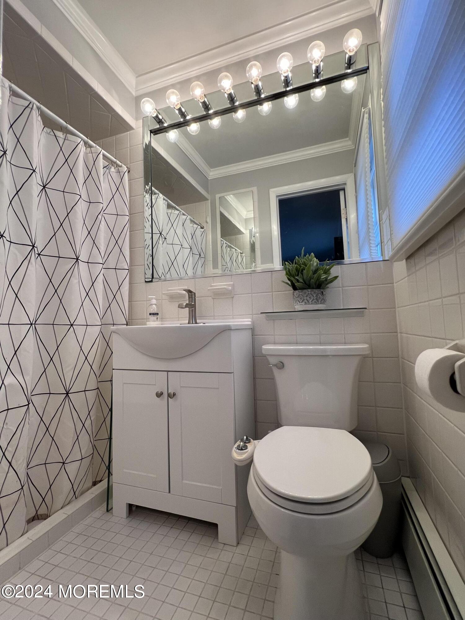 51 Lloyd Road Morganville, NJ 07751 - Photo 22 of 54 a bathroom with a toilet sink and mirror
