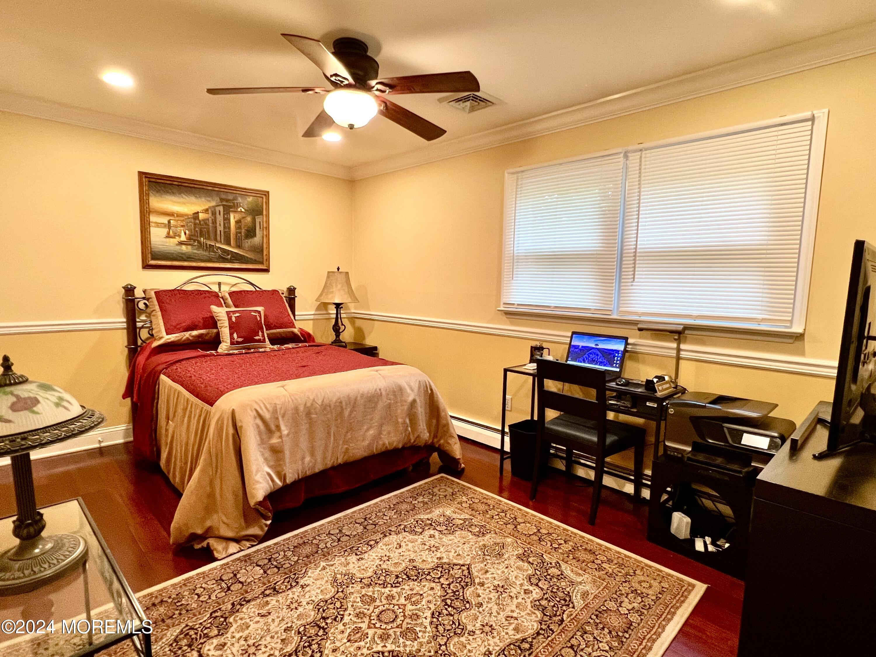 51 Lloyd Road Morganville, NJ 07751 - Photo 23 of 54 a bedroom with a bed and wooden floor