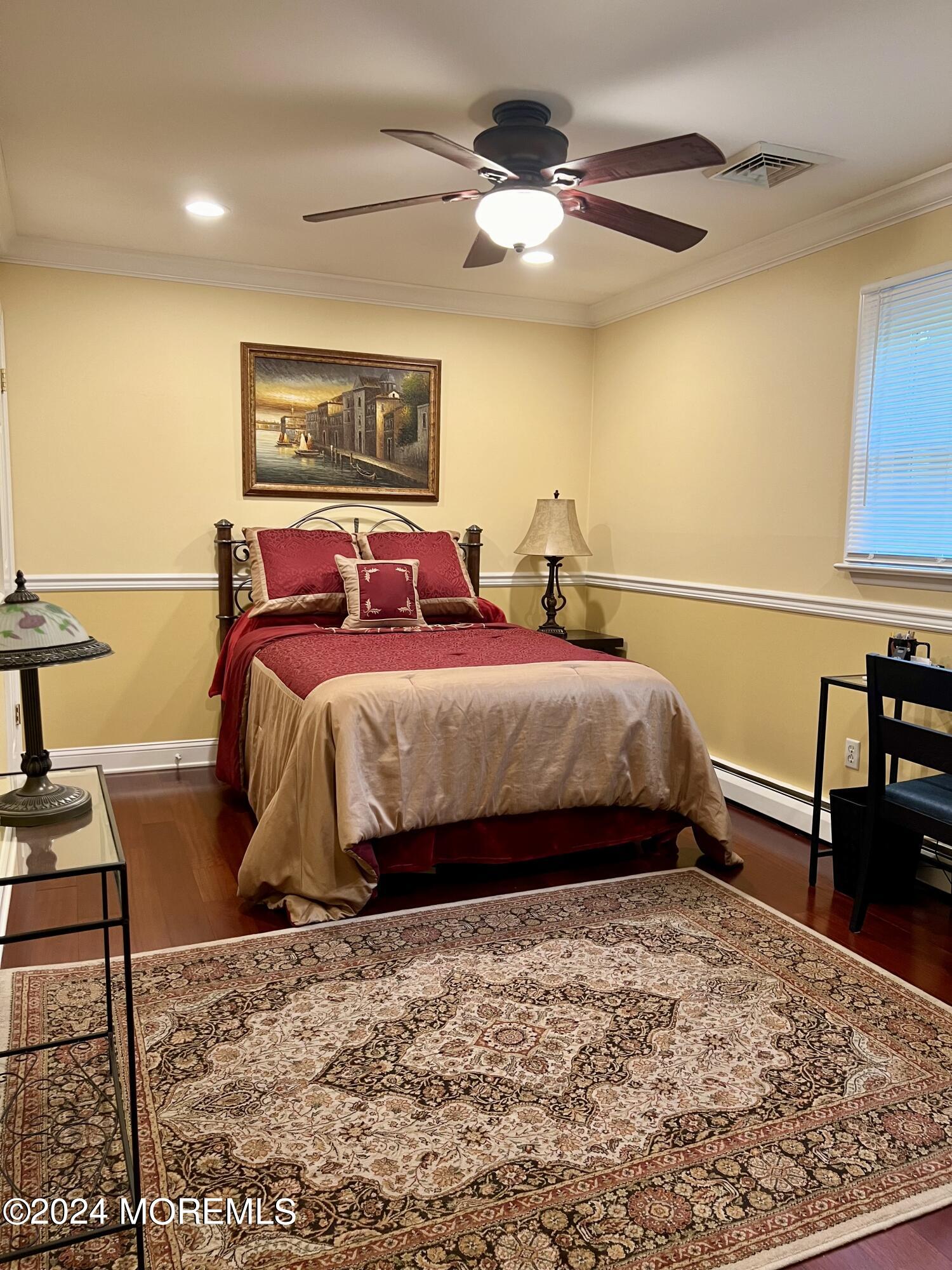 51 Lloyd Road Morganville, NJ 07751 - Photo 24 of 54 a bedroom with a bed and a table