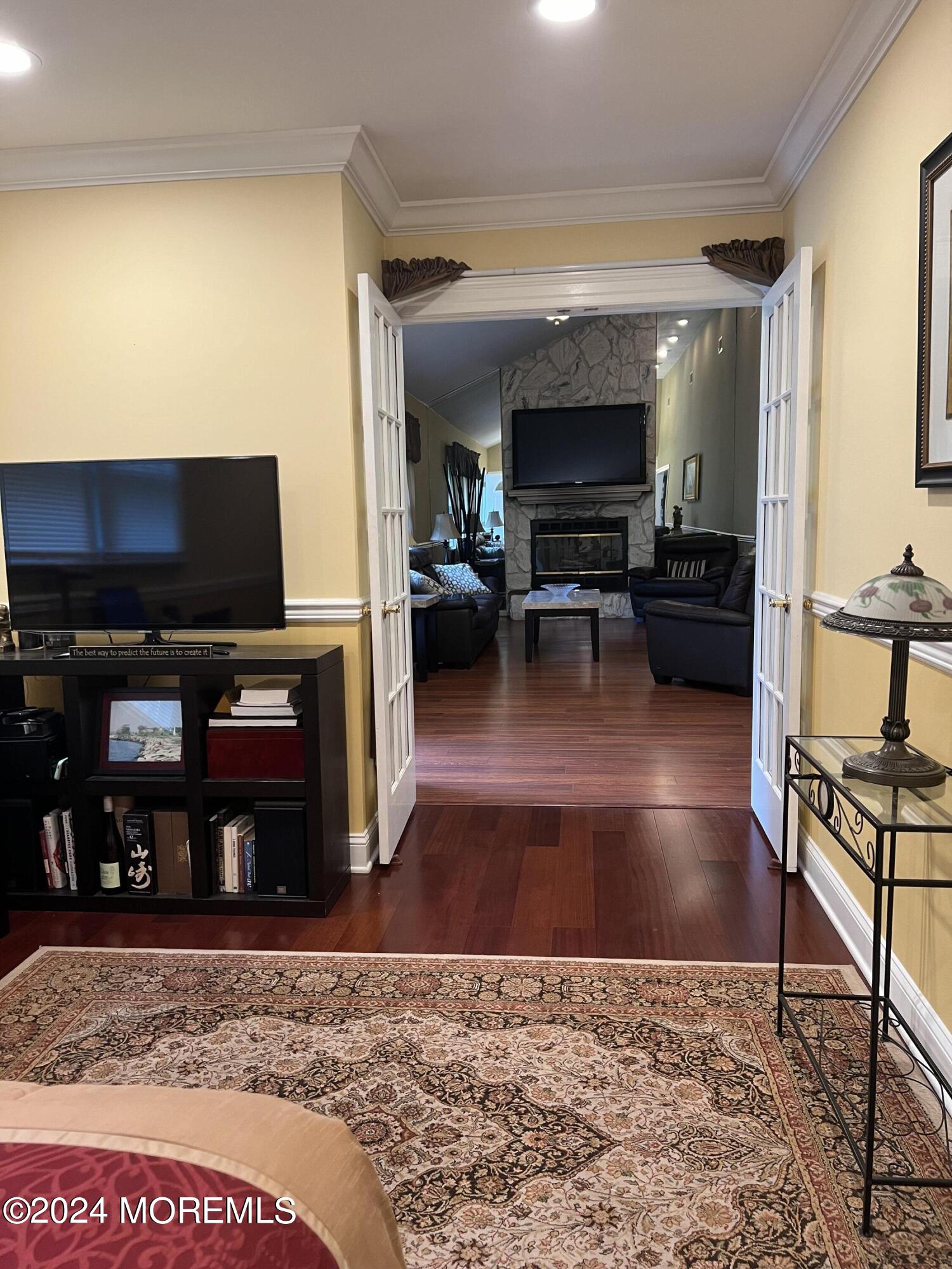 51 Lloyd Road Morganville, NJ 07751 - Photo 26 of 54 a living room with furniture and a flat screen tv