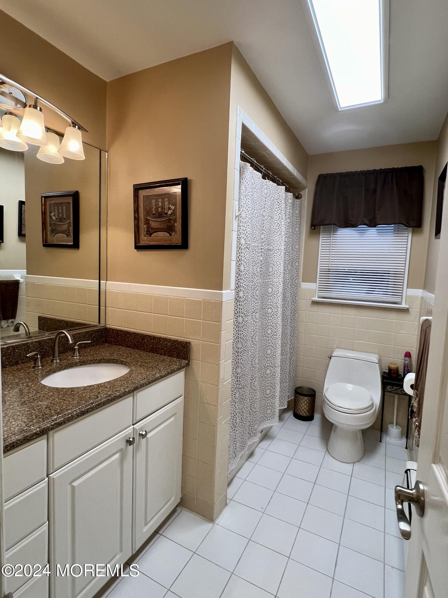 51 Lloyd Road Morganville, NJ 07751 - Photo 29 of 54 a spacious bathroom with a granite countertop sink a toilet and a mirror