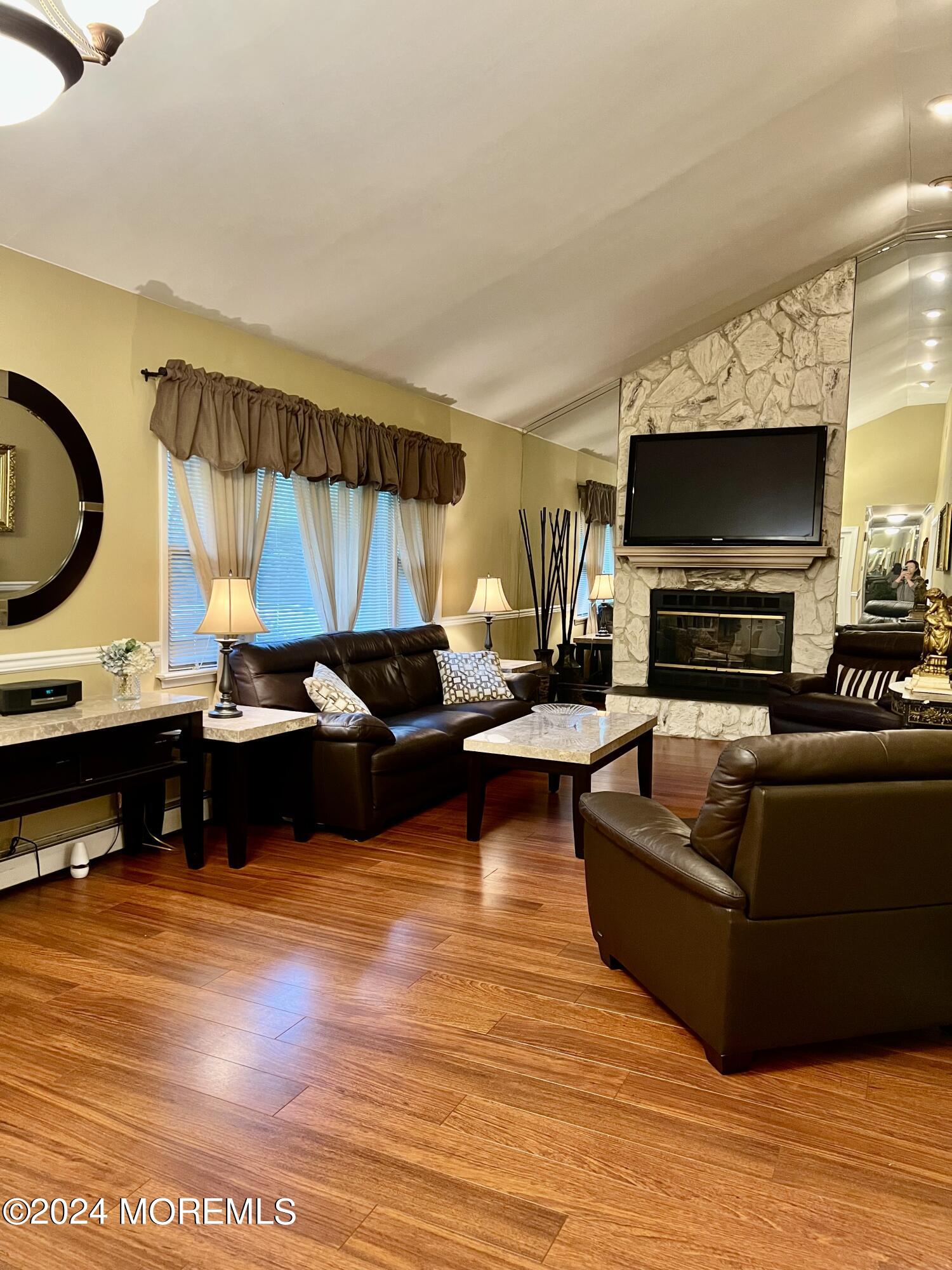 51 Lloyd Road Morganville, NJ 07751 - Photo 3 of 54 a living room with furniture and a flat screen tv