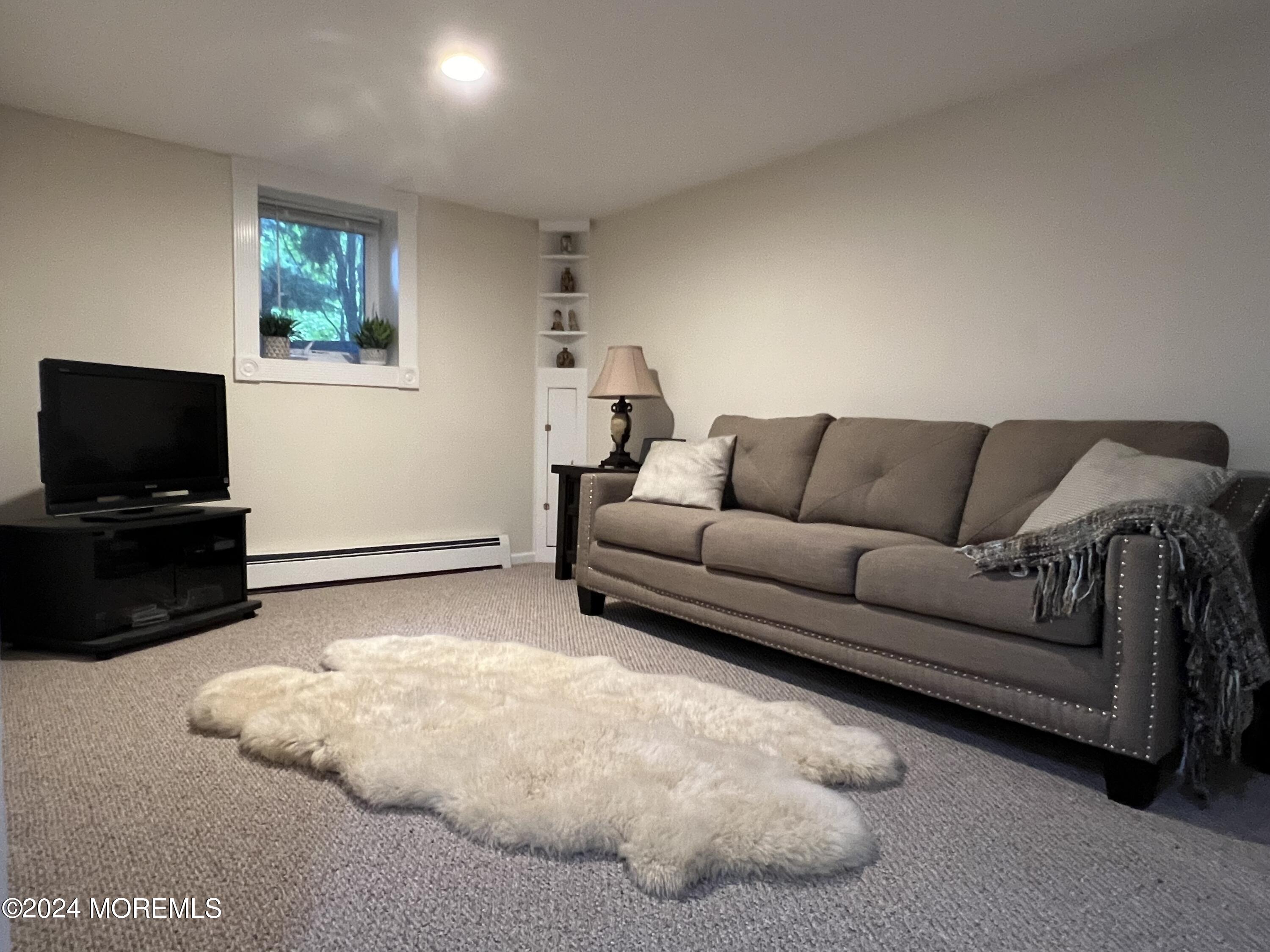 51 Lloyd Road Morganville, NJ 07751 - Photo 32 of 54 a living room with furniture and a flat screen tv