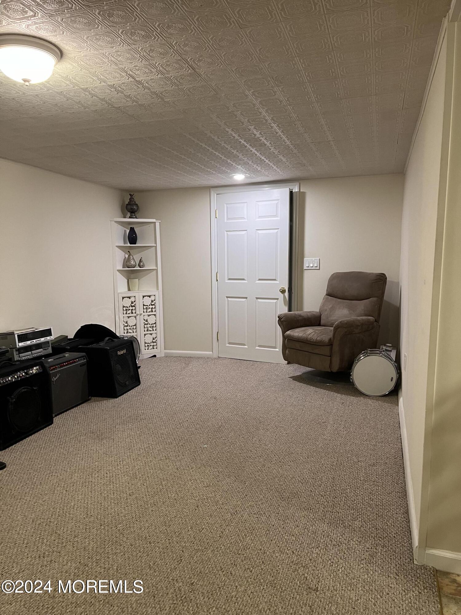51 Lloyd Road Morganville, NJ 07751 - Photo 33 of 54 a living room with furniture and a flat screen tv