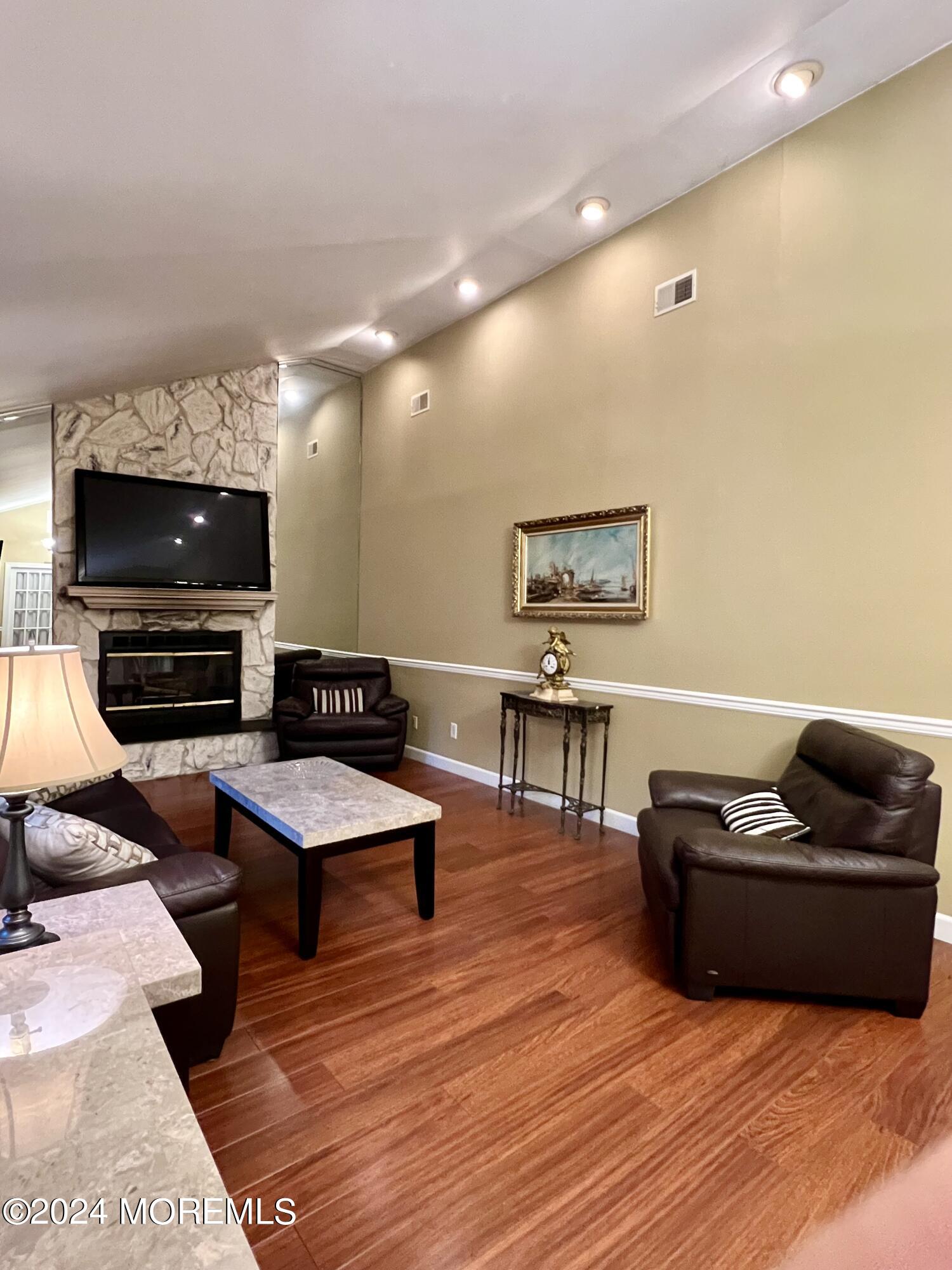 51 Lloyd Road Morganville, NJ 07751 - Photo 4 of 54 a living room with furniture and a flat screen tv