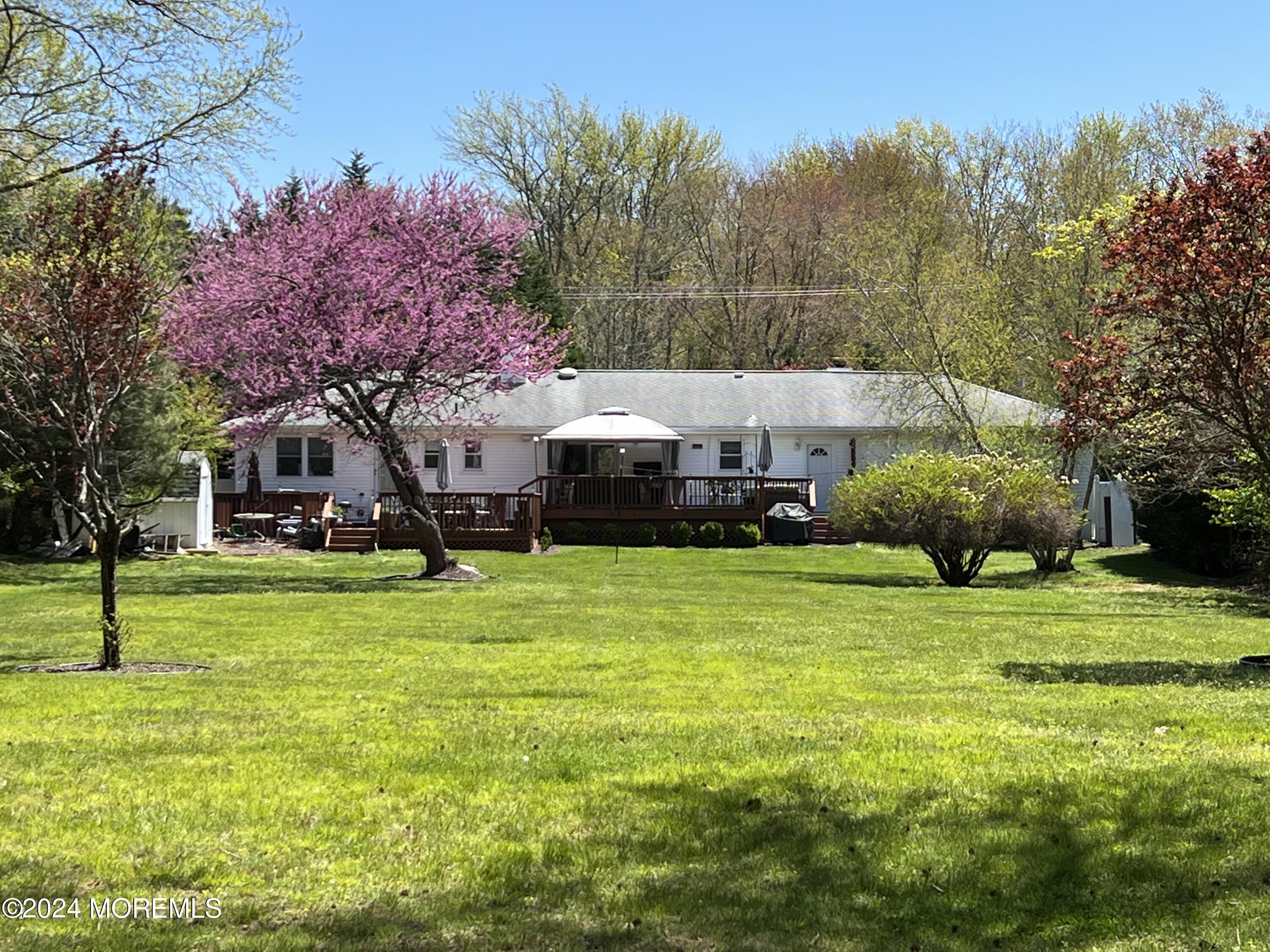 51 Lloyd Road Morganville, NJ 07751 - Photo 42 of 54 a front view of a house with a garden
