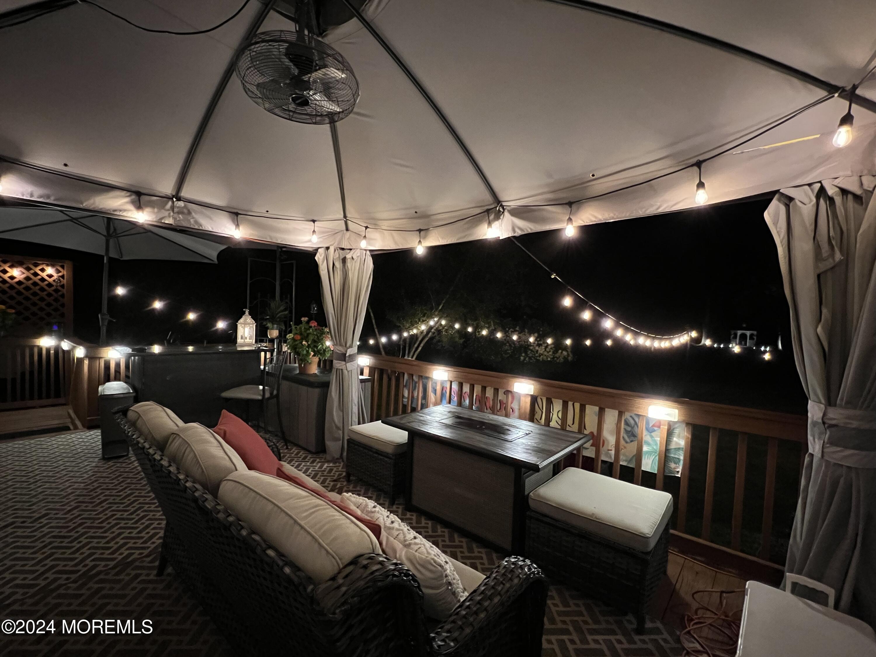 51 Lloyd Road Morganville, NJ 07751 - Photo 44 of 54 a living room with patio furniture and a chandelier