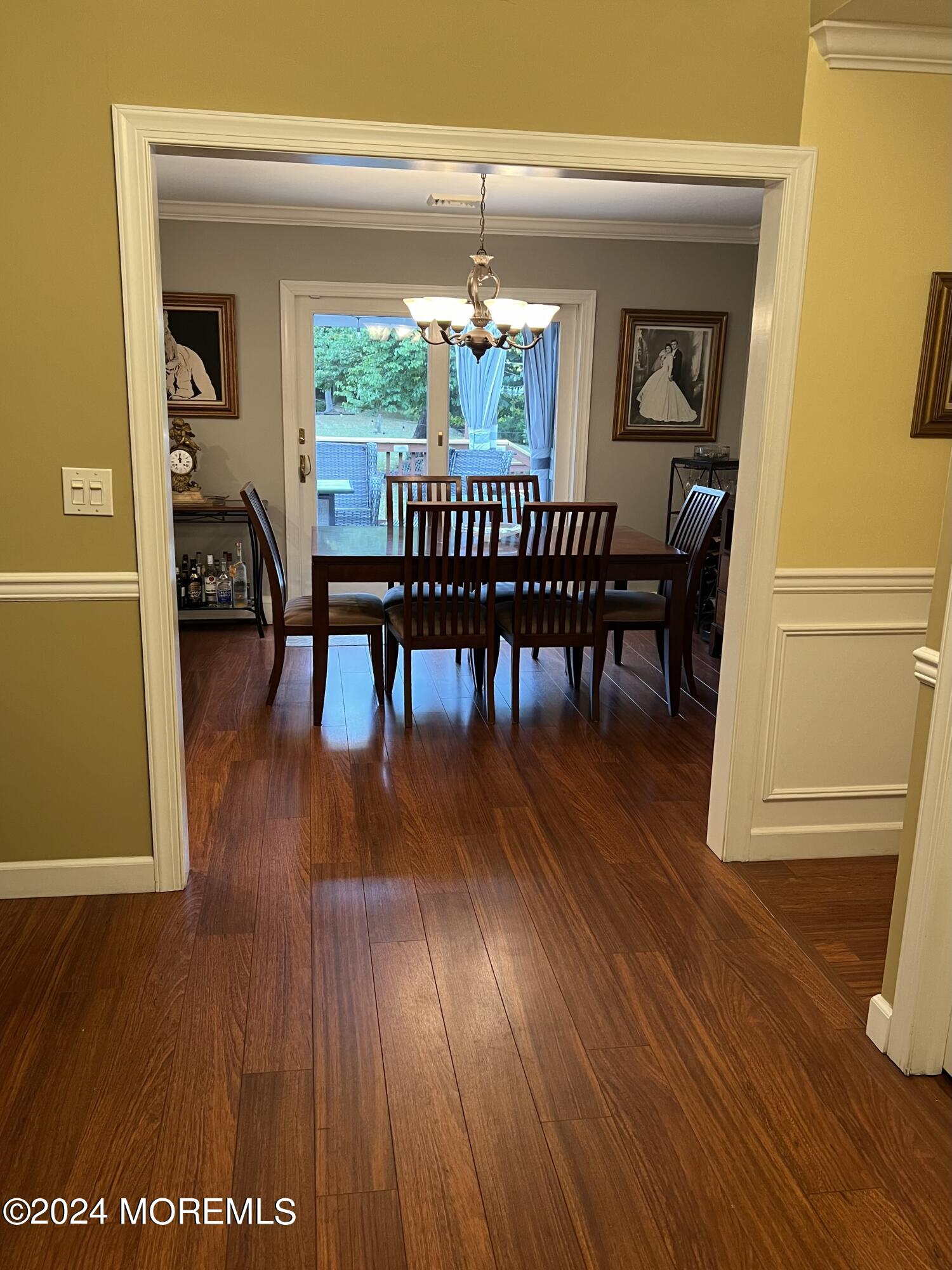 51 Lloyd Road Morganville, NJ 07751 - Photo 6 of 54 a dining room with furniture a chandelier and wooden floor