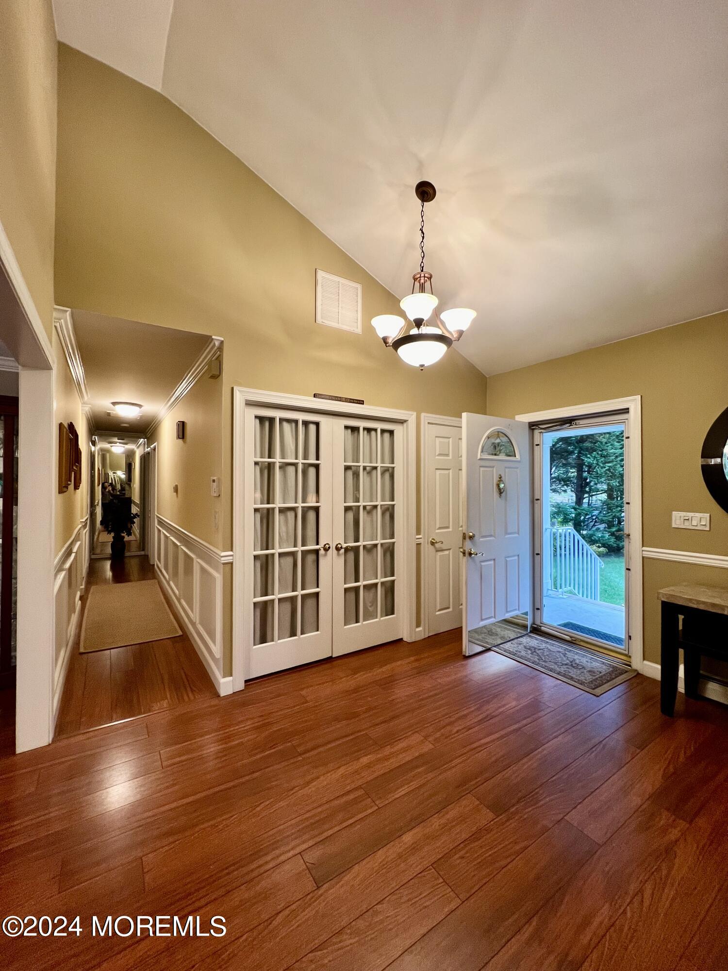 51 Lloyd Road Morganville, NJ 07751 - Photo 7 of 54 a view of an empty room with wooden floor fireplace and a window