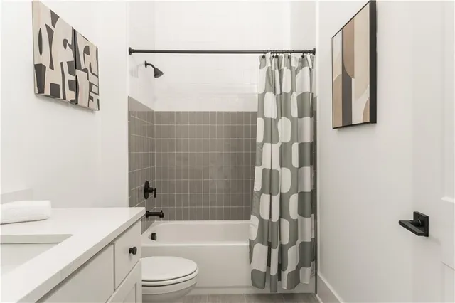 a bathroom with a shower a toilet and a sink