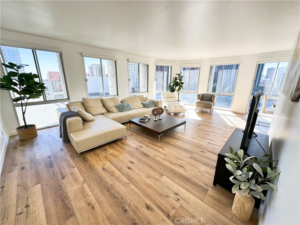 800 West 1st Street, Unit 905 Los Angeles, CA 90012 - Photo 1 of 47 a living room with furniture hard wood floor and a potted plant