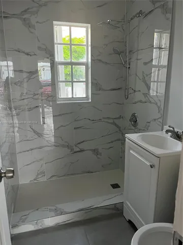 a bathroom with a bathtub sink and toilet