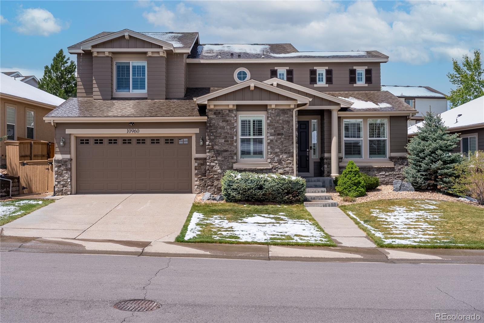 10960 Glengate Circle Highlands Ranch, CO 80130 - Photo 1 of 50 a front view of a house with a yard and garage