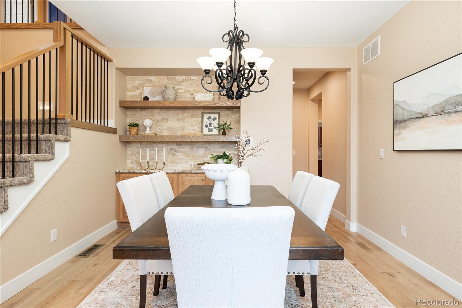 10960 Glengate Circle Highlands Ranch, CO 80130 - Photo 11 of 50 a view of a dining room with furniture and wooden floor
