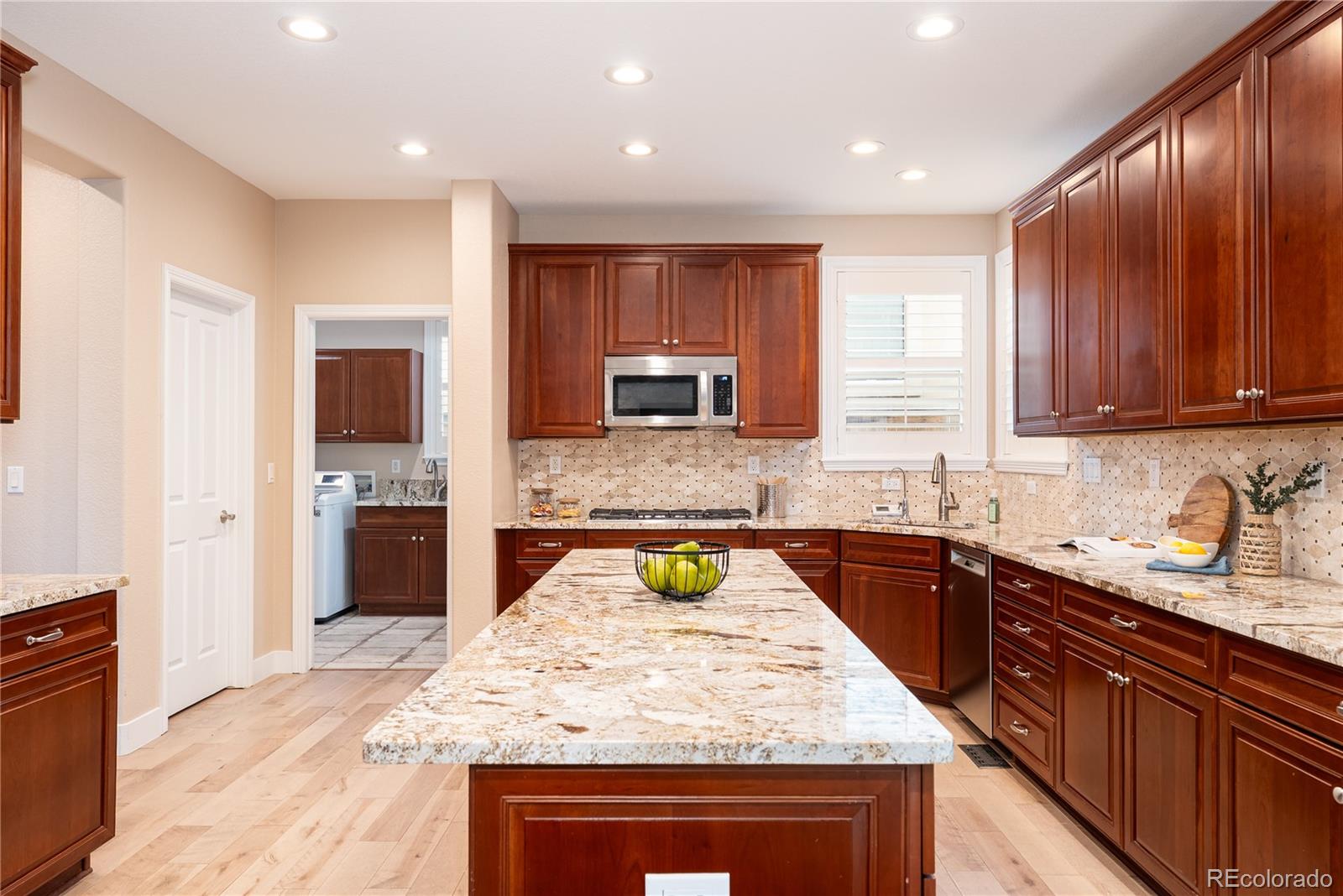 10960 Glengate Circle Highlands Ranch, CO 80130 - Photo 18 of 50 a kitchen with a sink stove top oven and microwave