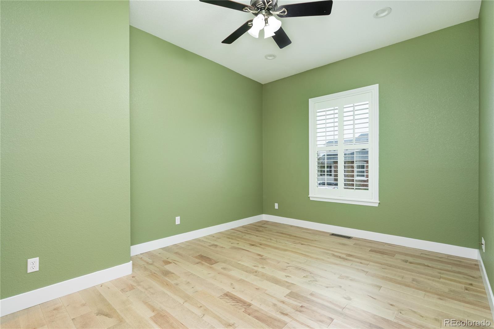 10960 Glengate Circle Highlands Ranch, CO 80130 - Photo 21 of 50 an empty room with a window and a ceiling fan