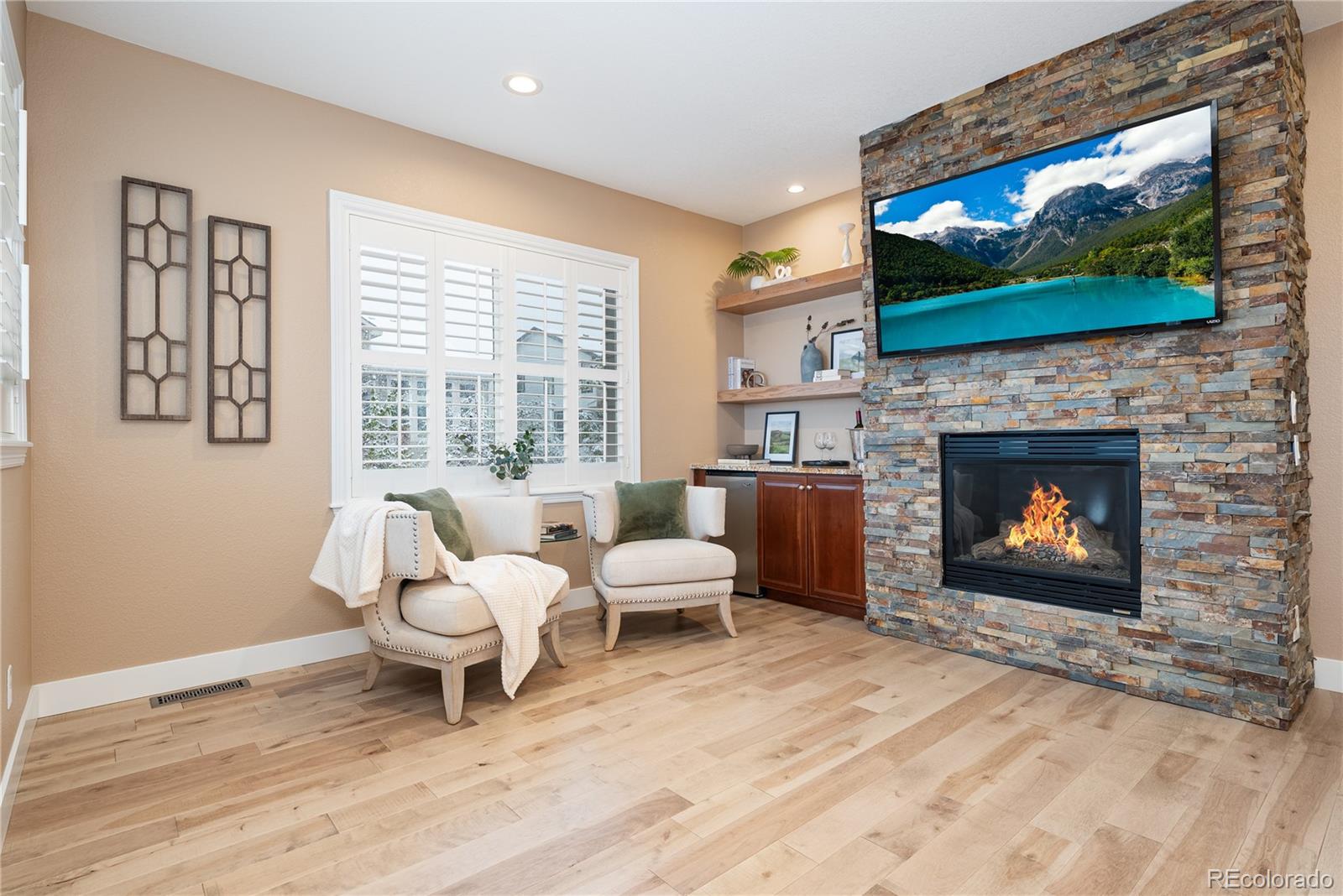 10960 Glengate Circle Highlands Ranch, CO 80130 - Photo 26 of 50 a living room with furniture a flat screen tv and a fireplace