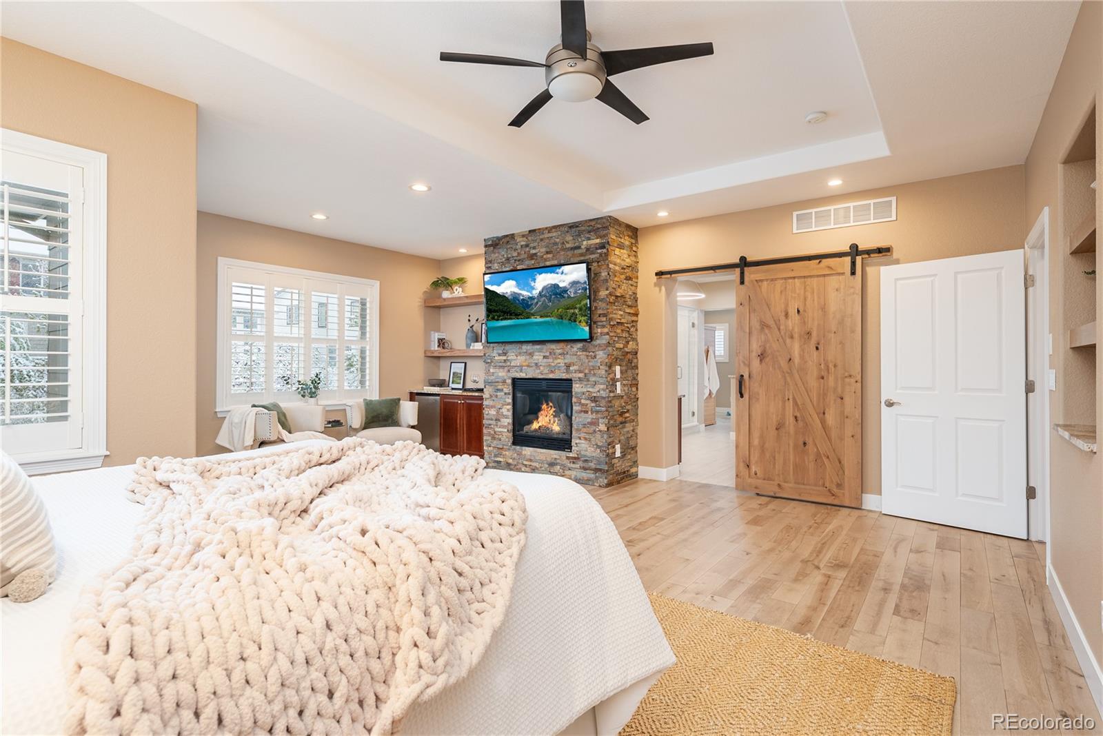 10960 Glengate Circle Highlands Ranch, CO 80130 - Photo 28 of 50 a spacious bedroom with a bed and a flat screen tv