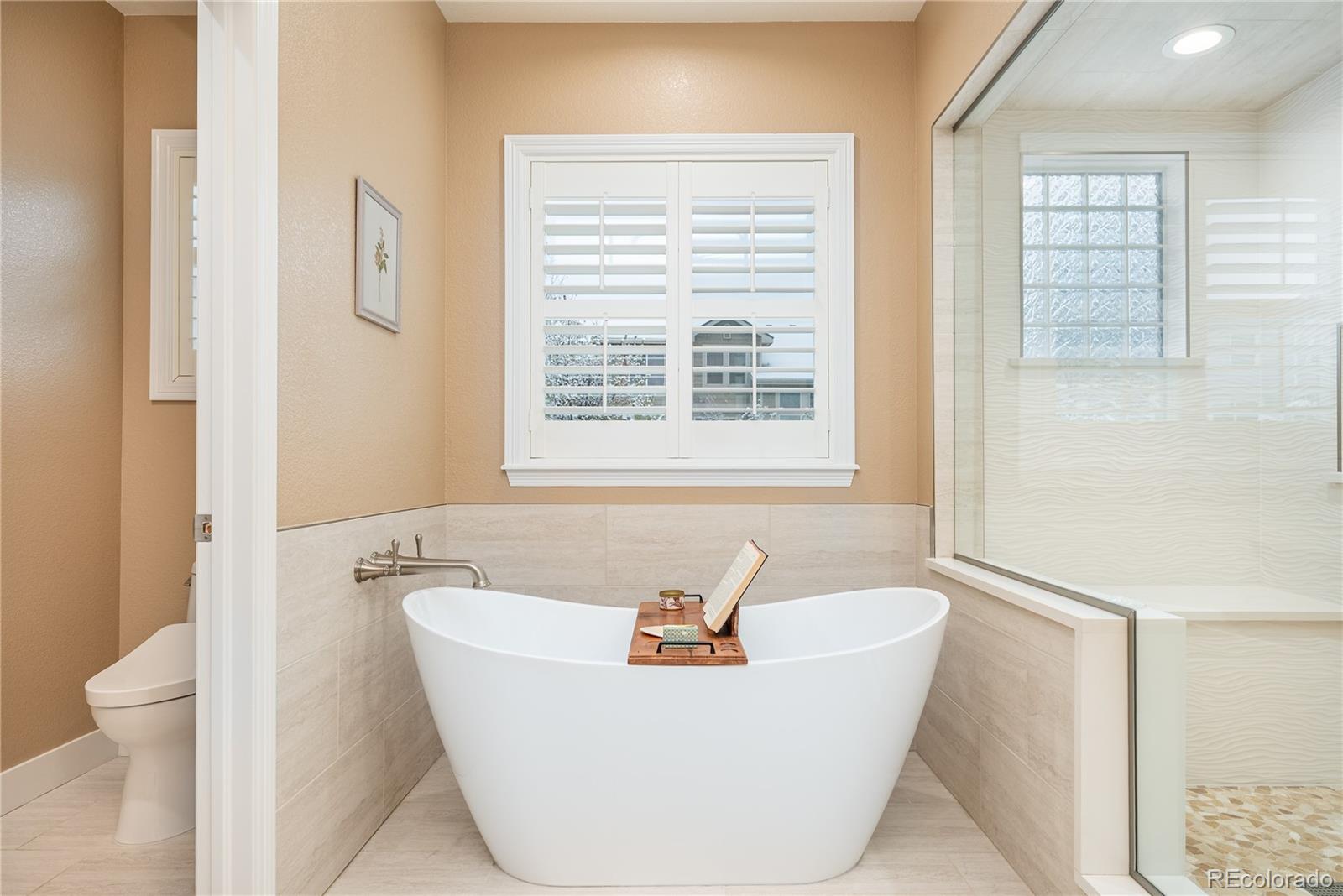 10960 Glengate Circle Highlands Ranch, CO 80130 - Photo 31 of 50 a white bath tub sitting next to a white toilet