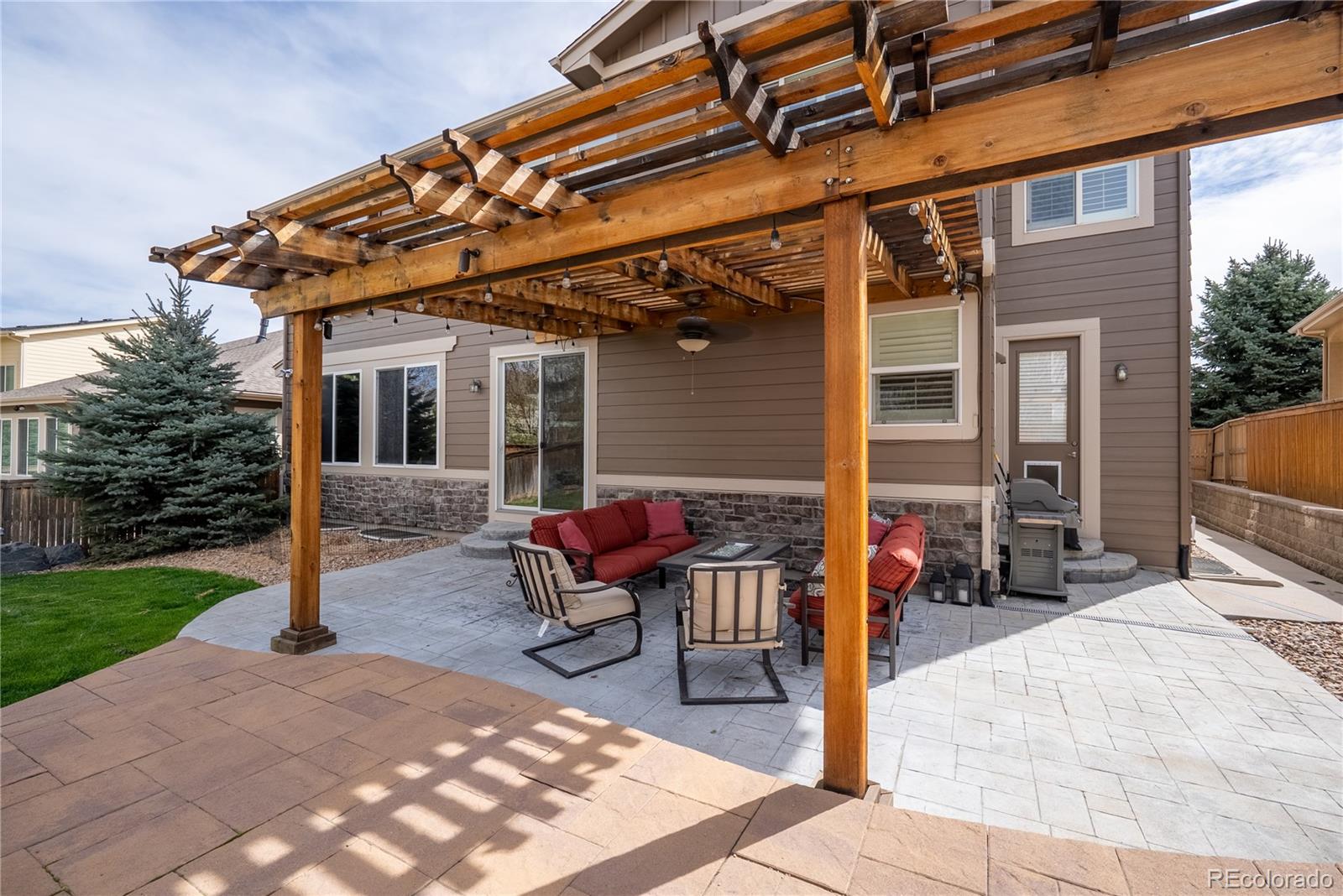 10960 Glengate Circle Highlands Ranch, CO 80130 - Photo 38 of 50 a view of a patio with table and chairs and floor to ceiling window